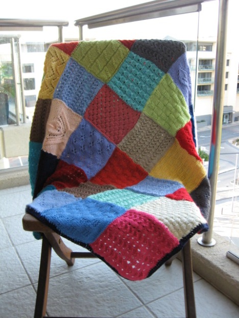 The knitted squares made into a quilt.